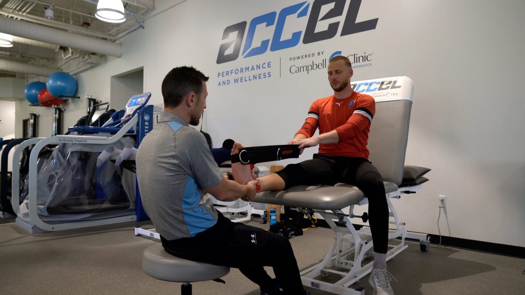 ACCEL physical therapist, Brad, administers injury recovery exercise.